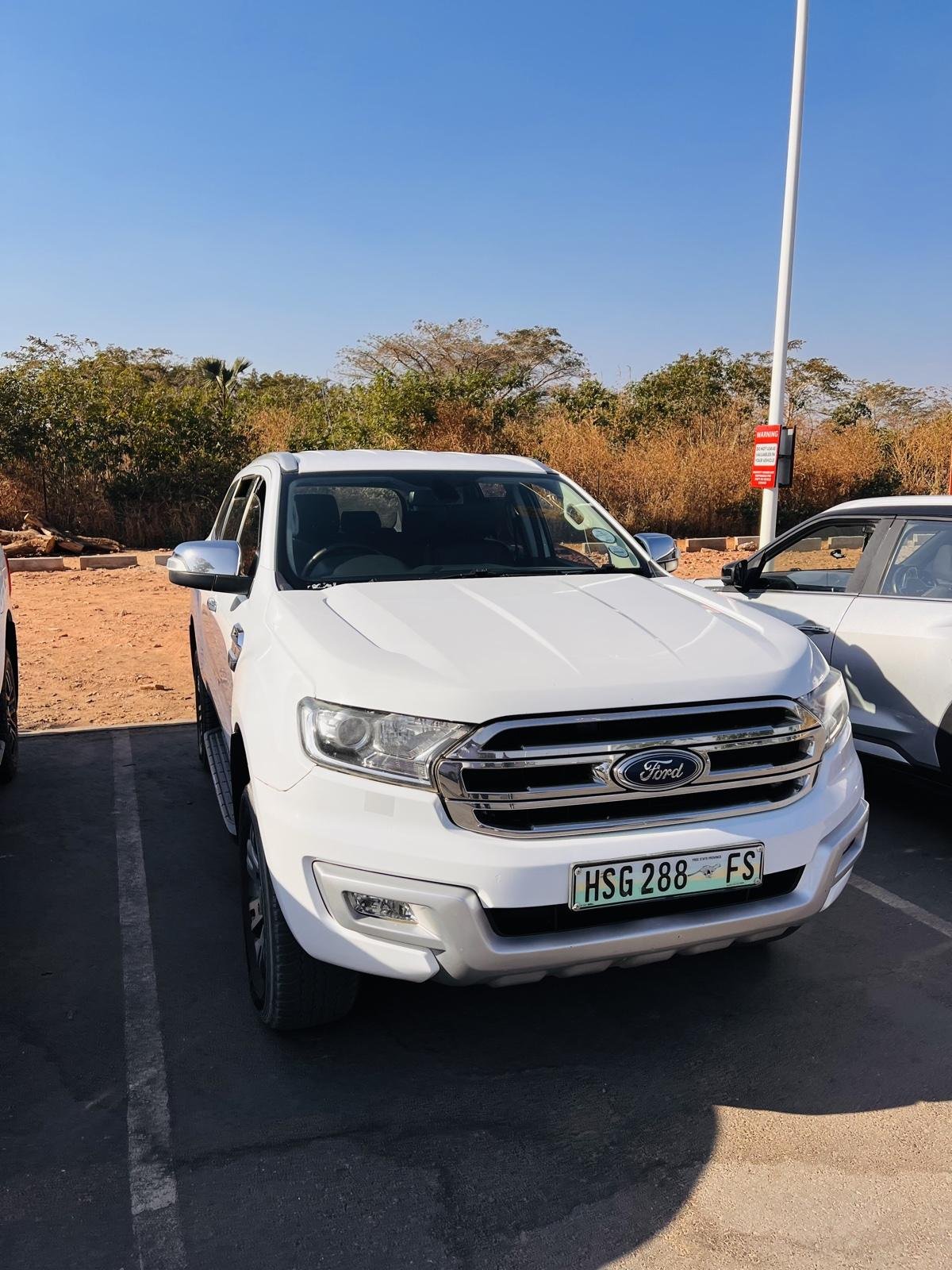 Front view of the white Ford Everest XLT showing the grille and headlights