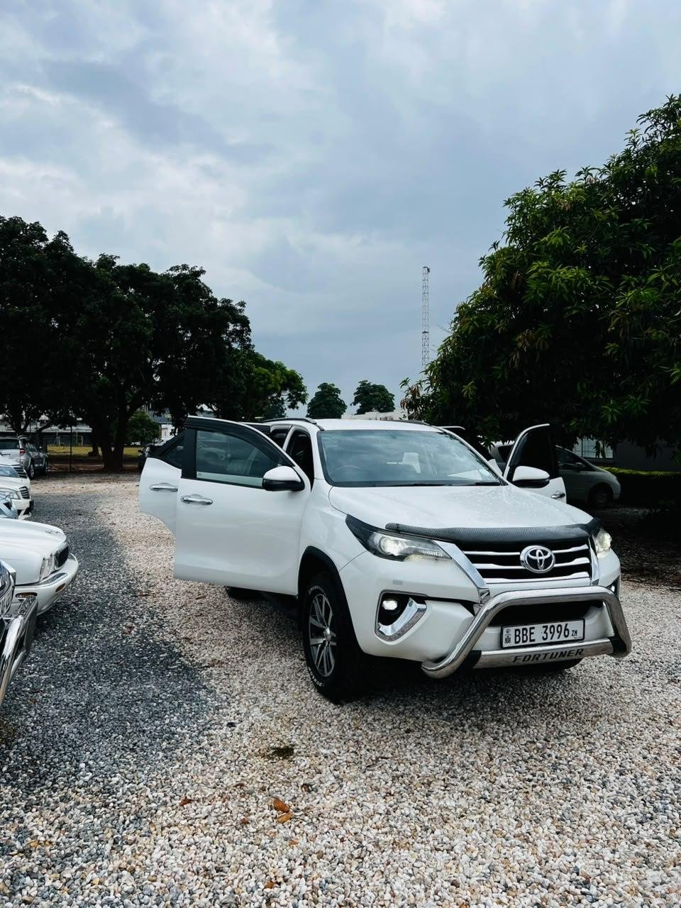 A white Toyota Fortuner from the Local Legends fleet with its doors open