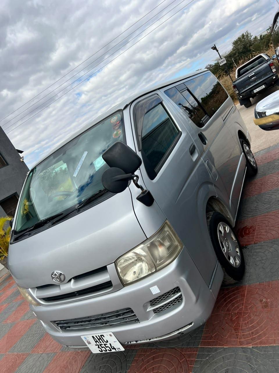 Front three-quarter view of the silver Toyota Hiace minibus